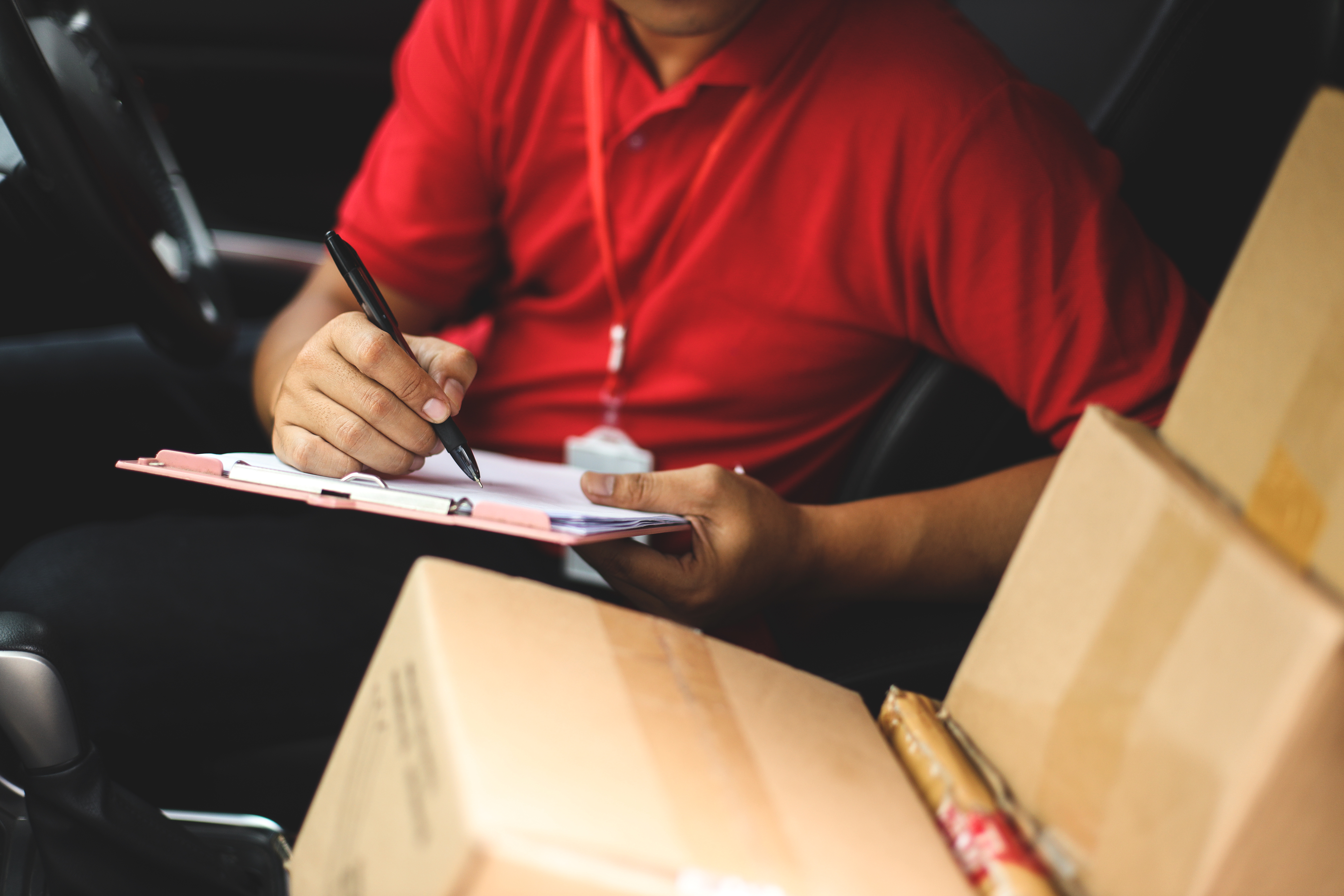 courier-sign-shipment-document-in-the-car-2022-09-28-22-46-29-utc